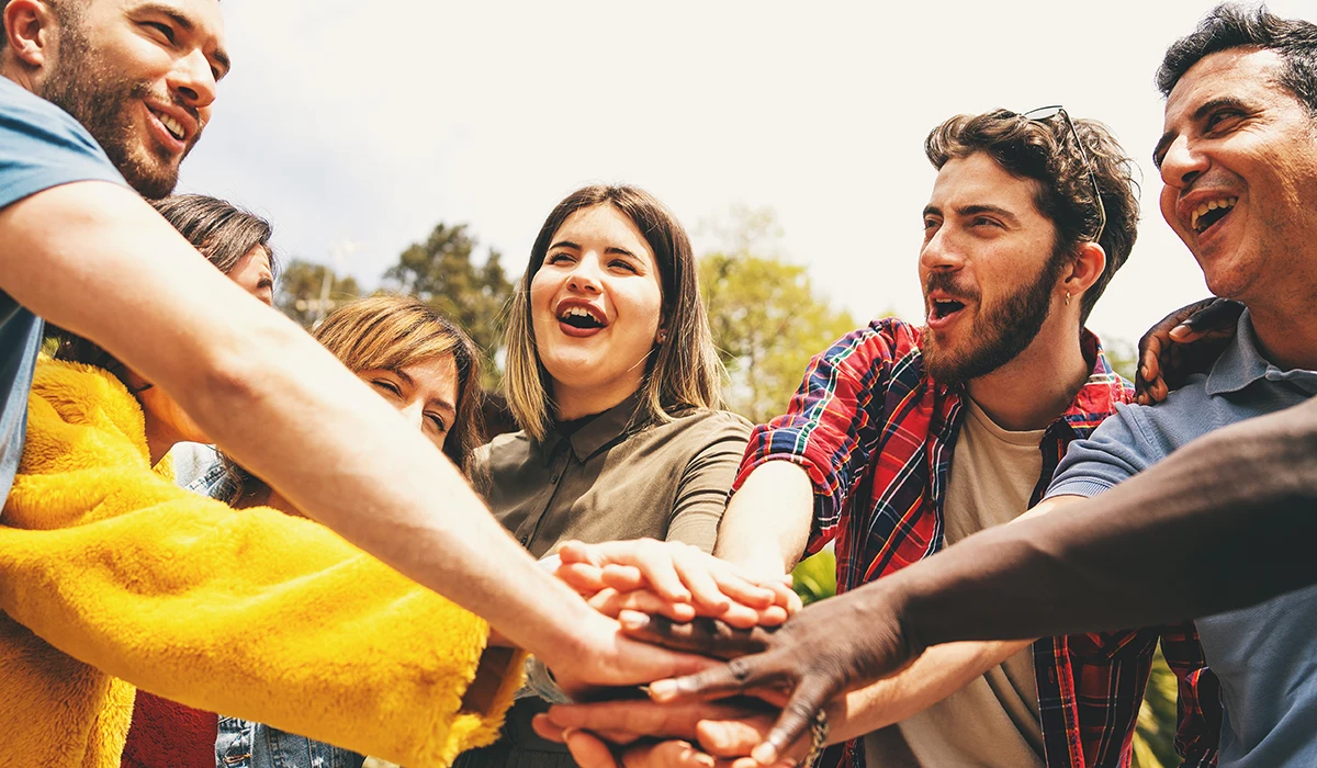 group of people with hands in center